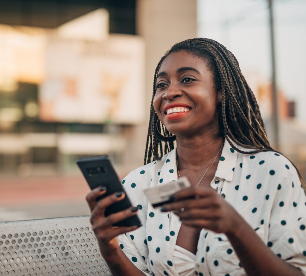 Smiling woman with phone and card