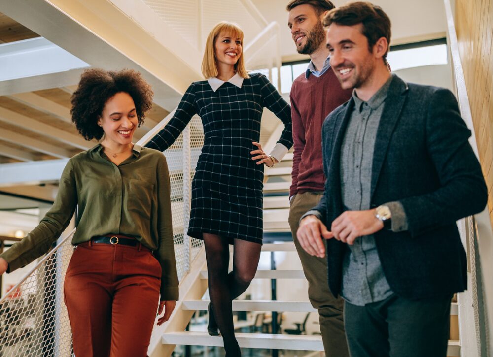 Smiling staff members on stairs